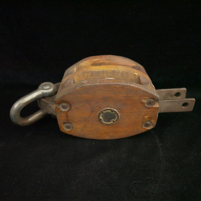 Antique 13-inch double sheave wooden block pulley.