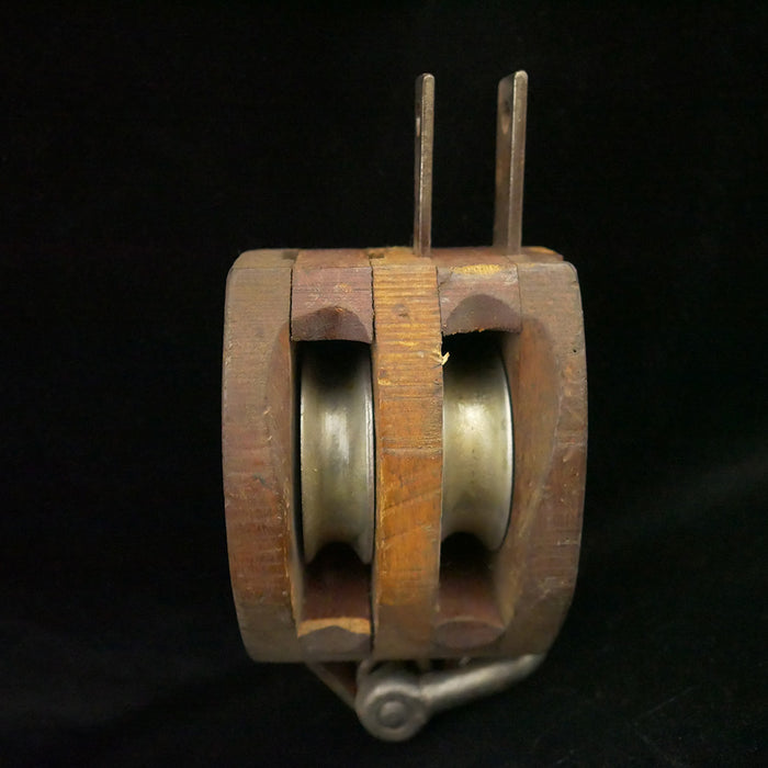 Antique 13-inch double sheave wooden block pulley.