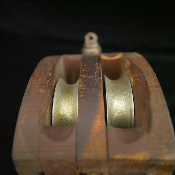 Antique 13-inch double sheave wooden block pulley.