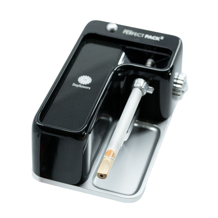 Top view of black DaySavers filling machine with adjustment knob, tray, and filling tube