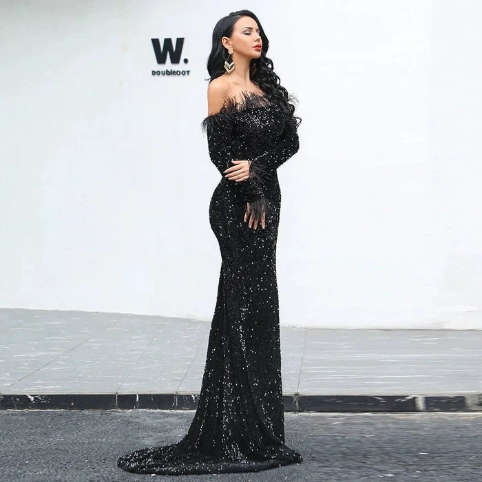 Elegant black evening dress by MANDOTOS featuring a fitted bodice and flowing skirt, perfect for formal occasions.