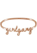 Wanderlust + Co Girlgang Bangle in rose gold with cursive girlgang script on rose gold plated stainless steel hinged bangle bracelet — front view