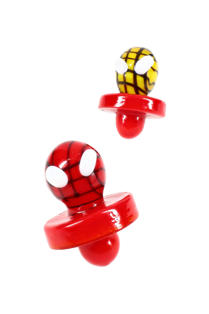 Two Spider Hero glass carb caps in red and yellow, character topper design, dab accessory for banger airflow control