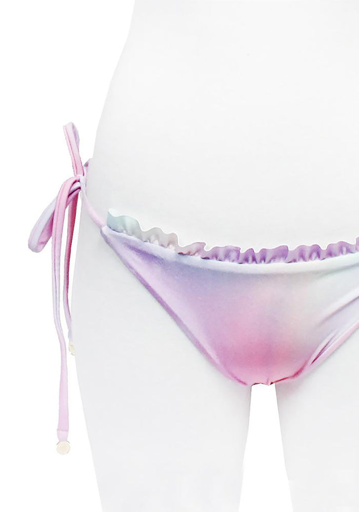 Wildfox Swim Fairy Hologram Ruffle String Bikini Bottom in pastel rainbow with ruffle detail on hologram print polyester spandex festival swimwear — reverse stripe view